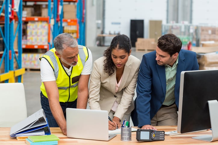 Warehouse-managers-and-worker-discussing-with-laptop-653174280_727x484