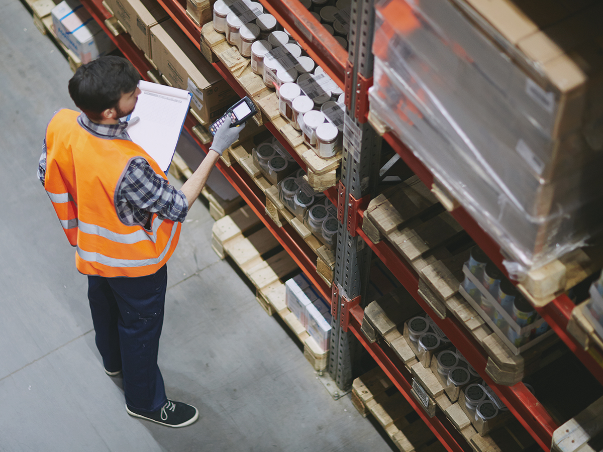 Warehouse employee checking if inventory meets inventory kpis
