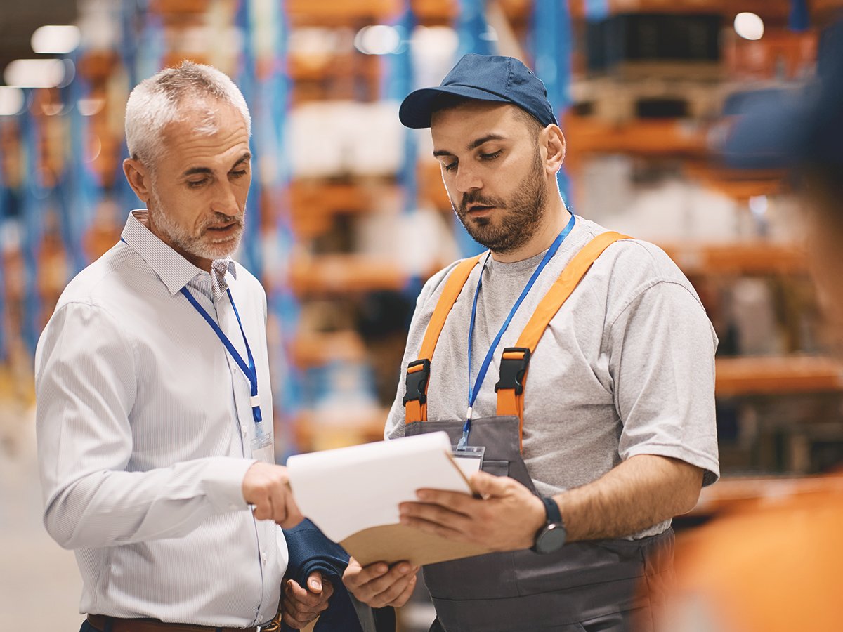 Supply chain manager evaluating supply chain risks with supply chain employee
